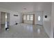 Bright living room with terrazzo floors, a large window with blinds, and a classic front door at 11735 86Th Ave, Seminole, FL 33772