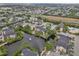 Scenic aerial view showcasing the condo community built around a pond with fountain and nearby highway at 11901 4Th N St # 5111, St Petersburg, FL 33716