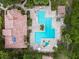 Overhead view of the community pool with sunning decks, multiple lounge chairs, and surrounding foliage at 11901 4Th N St # 5111, St Petersburg, FL 33716