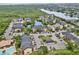 Aerial view showcasing the condo community built around a pond with fountain and lush natural surroundings at 11901 4Th N St # 5111, St Petersburg, FL 33716