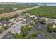 Panoramic aerial view showcasing the condo community near a highway, pond, and wooded landscape at 11901 4Th N St # 5111, St Petersburg, FL 33716