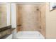 Close up on a shower-tub featuring granite countertop, modern fixtures, and a tiled shower-tub combo at 11901 4Th N St # 5111, St Petersburg, FL 33716