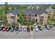 Well-maintained condo building with a black roof, landscaped grounds, ample parking, and multiple levels of living at 11901 4Th N St # 5111, St Petersburg, FL 33716