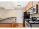 Efficient kitchen featuring granite countertops, stainless steel appliances, and wood-look flooring at 11901 4Th N St # 5111, St Petersburg, FL 33716