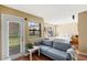 Bright living room featuring a comfortable blue sofa, neutral walls, and a door leading to the outside at 11901 4Th N St # 5111, St Petersburg, FL 33716