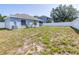 Home's spacious backyard featuring green space and a full white fence around the perimeter at 12136 Luftburrow Ln, Hudson, FL 34669
