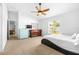 Carpeted bedroom featuring a ceiling fan, natural light, a modern bed frame and coordinating dressers at 12136 Luftburrow Ln, Hudson, FL 34669