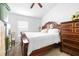 Bright bedroom features a plush bed, dark wood furniture, and a window for natural light at 12136 Luftburrow Ln, Hudson, FL 34669