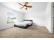 Neutral bedroom with carpet, ceiling fan, a large window, and sleek, modern bed frame at 12136 Luftburrow Ln, Hudson, FL 34669