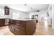 Open-concept kitchen with dark wood island, stainless steel appliances, and adjacent living spaces, perfect for entertaining at 12136 Luftburrow Ln, Hudson, FL 34669