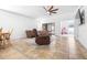 Inviting living room with tile floors, a leather sofa, a ceiling fan, and access to the patio at 12136 Luftburrow Ln, Hudson, FL 34669