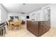 Open-concept floor plan with tiled floors, a dark wood island, and ample space for dining at 12136 Luftburrow Ln, Hudson, FL 34669