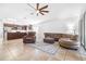 Cozy living room featuring tile flooring, brown leather furniture, ceiling fan and an open layout at 12136 Luftburrow Ln, Hudson, FL 34669