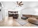 Spacious living area showcasing an open layout, tile floors, and a kitchen with dark cabinets at 12136 Luftburrow Ln, Hudson, FL 34669