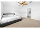 Serene main bedroom with plush carpeting, a ceiling fan, and an en-suite bathroom at 12136 Luftburrow Ln, Hudson, FL 34669