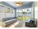 Bright sunroom with comfortable seating, ceiling fan, and views of the backyard at 12136 Luftburrow Ln, Hudson, FL 34669