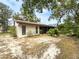 The home's exterior and landscaped backyard are seen from an angle view at 1228 Rainbrook Cir, Valrico, FL 33596