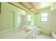 Charming bathroom featuring a marble vanity, large mirror, and tiled flooring at 1228 Rainbrook Cir, Valrico, FL 33596