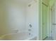 Clean bathroom with bathtub, tiled walls, and a linen closet at 1228 Rainbrook Cir, Valrico, FL 33596