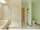 This bathroom features a skylight, a bathtub, glass enclosed shower, and a toilet at 1228 Rainbrook Cir, Valrico, FL 33596