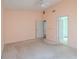 This bedroom features a ceiling fan, light peach colored walls and multiple doors at 1228 Rainbrook Cir, Valrico, FL 33596