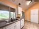 Well lit kitchen with a stainless steel sink, dishwasher, and white cabinets at 1228 Rainbrook Cir, Valrico, FL 33596
