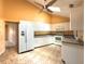 Bright kitchen with white cabinets, neutral countertops, and a ceiling fan at 1228 Rainbrook Cir, Valrico, FL 33596