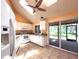 Bright kitchen featuring white appliances, tile floors, and a sliding glass door to the patio at 1228 Rainbrook Cir, Valrico, FL 33596