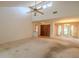 Expansive living room featuring high ceilings, neutral carpet, and large front entrance doors at 1228 Rainbrook Cir, Valrico, FL 33596