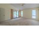 This main bedroom features a ceiling fan, neutral paint color, and sliding glass door at 1228 Rainbrook Cir, Valrico, FL 33596