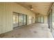 This porch has two ceiling fans, light yellow siding, and screened windows at 1228 Rainbrook Cir, Valrico, FL 33596