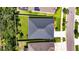 Aerial view of the property showcasing the roof, expansive lawn, and bordering landscape at 12957 Satin Lily Dr, Riverview, FL 33579