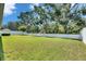 Expansive, verdant backyard with mature trees and privacy fencing creating a serene outdoor space at 12957 Satin Lily Dr, Riverview, FL 33579