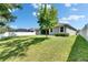 Spacious backyard with green lawn and privacy fence at 12957 Satin Lily Dr, Riverview, FL 33579