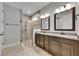Modern bathroom features a walk-in shower, double vanity, and neutral color palette at 12957 Satin Lily Dr, Riverview, FL 33579
