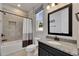 Bathroom with shower-tub combo, granite countertop, and dark vanity at 12957 Satin Lily Dr, Riverview, FL 33579