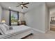 Bright bedroom features a ceiling fan, neutral paint, and a window with a lovely view at 12957 Satin Lily Dr, Riverview, FL 33579