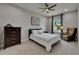 Inviting bedroom with neutral colors, a ceiling fan, and a large window at 12957 Satin Lily Dr, Riverview, FL 33579