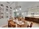 Dining room with natural light, view of the kitchen, living room, and a wall of pictures at 12957 Satin Lily Dr, Riverview, FL 33579