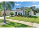 Inviting single-story home with well-manicured lawn, mature landscaping, and a welcoming facade at 12957 Satin Lily Dr, Riverview, FL 33579