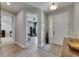 Inviting foyer with wood-look floors, stylish console table, and an open view into adjacent rooms at 12957 Satin Lily Dr, Riverview, FL 33579