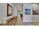 Spacious hallway with wood-look floors leading to open-concept living and dining areas at 12957 Satin Lily Dr, Riverview, FL 33579