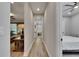 Hallway with hardwood flooring and neutral paint leads to bedroom and living area at 12957 Satin Lily Dr, Riverview, FL 33579