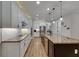 Spacious kitchen with white cabinets, stainless steel appliances, granite countertops, and a large kitchen island at 12957 Satin Lily Dr, Riverview, FL 33579