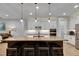 Kitchen island with barstool seating, pendant lighting, white cabinets, stainless appliances, and a pantry at 12957 Satin Lily Dr, Riverview, FL 33579