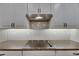 Close-up of the kitchen cooktop and backsplash, featuring sleek appliances and elegant finishes at 12957 Satin Lily Dr, Riverview, FL 33579