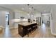 Bright open kitchen with a large island, stainless steel appliances, and modern finishes and barstool seating at 12957 Satin Lily Dr, Riverview, FL 33579