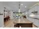 Spacious kitchen with a large island, granite countertops, stainless steel appliances, and an open view to the living room at 12957 Satin Lily Dr, Riverview, FL 33579
