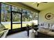 Relaxing lanai features comfortable seating and screened windows with a scenic view at 12957 Satin Lily Dr, Riverview, FL 33579
