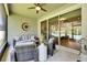 Covered lanai features comfortable seating and an outdoor living area at 12957 Satin Lily Dr, Riverview, FL 33579